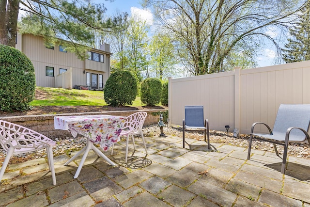 view of patio with fence and outdoor dining space