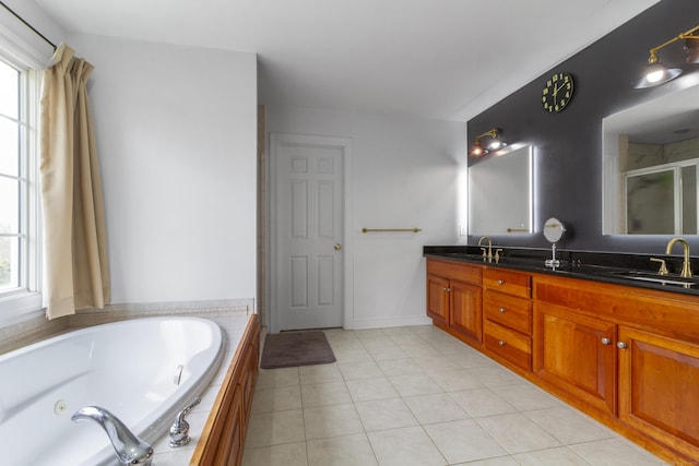 bathroom featuring a whirlpool tub, double vanity, a shower stall, and tile patterned flooring