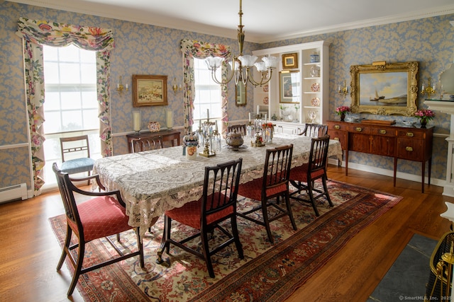dining space featuring a wealth of natural light, a chandelier, wallpapered walls, and wood finished floors