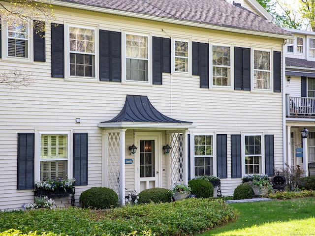 colonial inspired home with metal roof and a standing seam roof