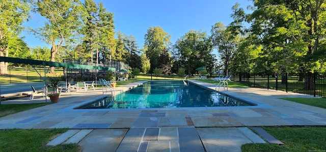 view of swimming pool with a patio area, a fenced in pool, and fence