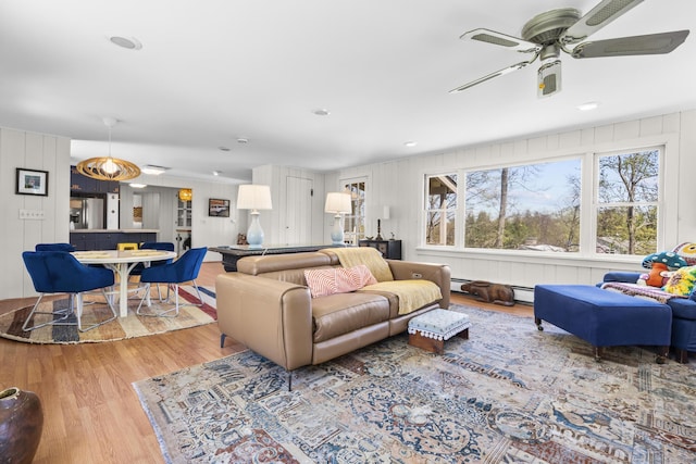living room featuring a ceiling fan and wood finished floors
