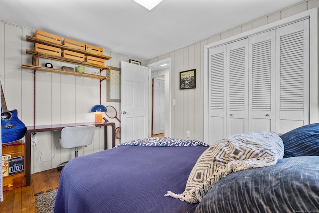 bedroom featuring hardwood / wood-style floors and a closet