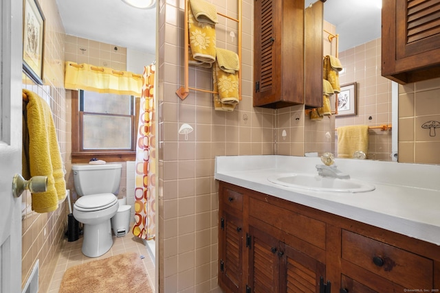 full bathroom featuring tile patterned flooring, vanity, toilet, tile walls, and visible vents