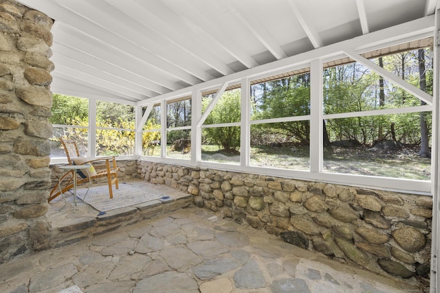 unfurnished sunroom featuring lofted ceiling