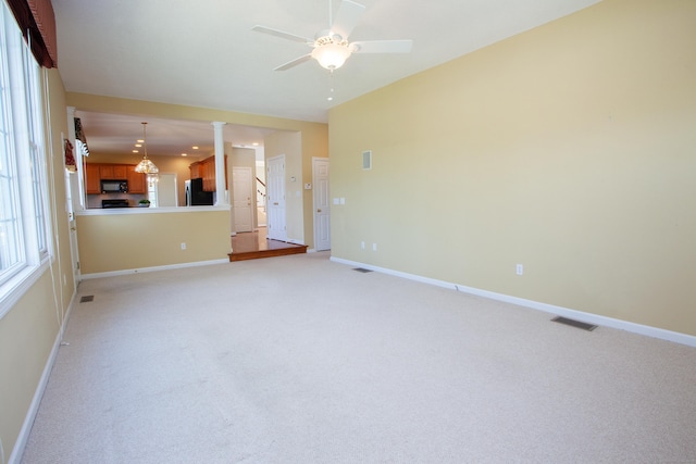 unfurnished living room with visible vents and baseboards