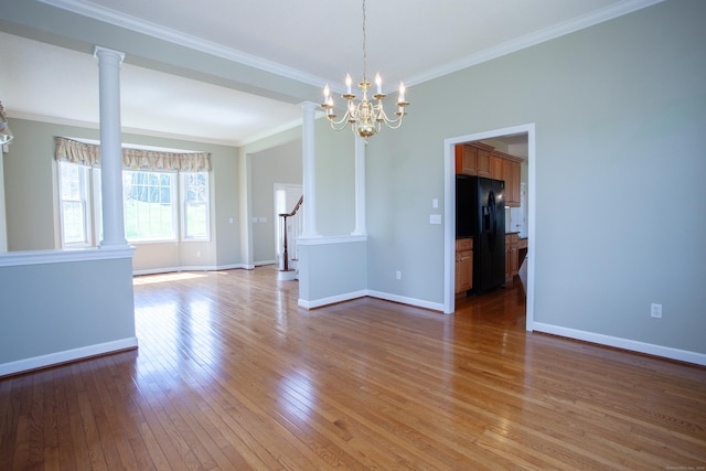 interior space with crown molding, stairs, baseboards, ornate columns, and light wood-style flooring