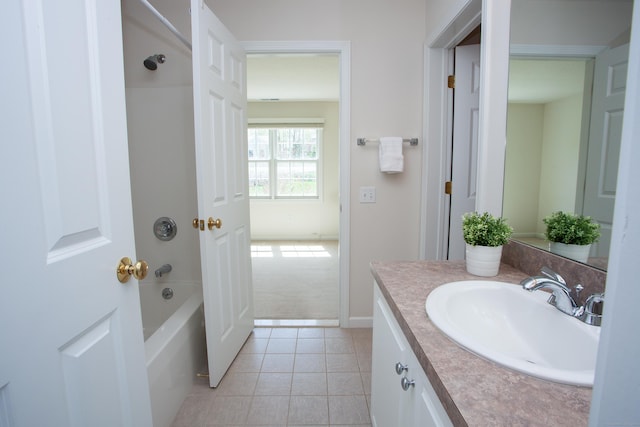 bathroom featuring vanity, tile patterned flooring, baseboards, and tub / shower combination