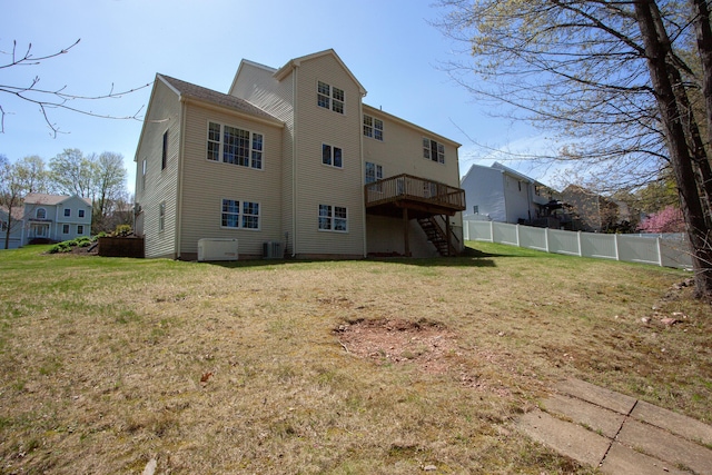 rear view of property with fence, stairs, a wooden deck, cooling unit, and a lawn