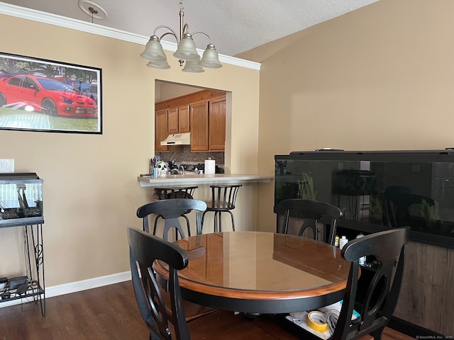 dining area featuring baseboards, a notable chandelier, dark wood-style floors, and ornamental molding