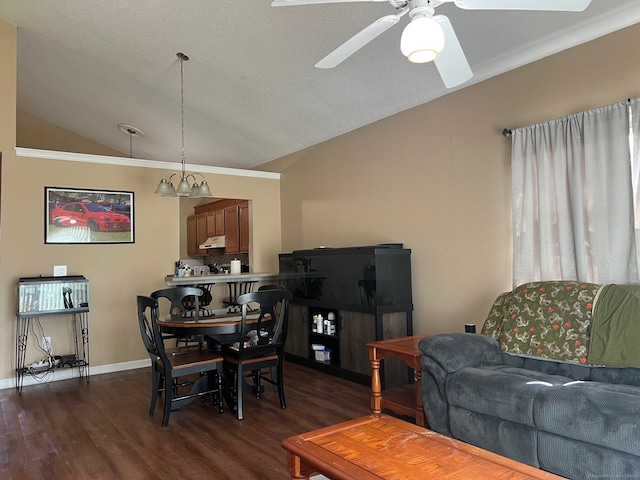 living area with ceiling fan with notable chandelier, baseboards, dark wood-type flooring, and lofted ceiling