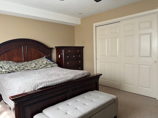 bedroom with a closet, a textured ceiling, and carpet