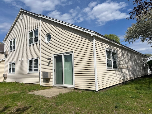 rear view of property featuring a yard
