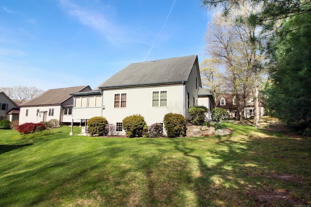 5 Marjories Way Unit 5, East Lyme, CT 06357 - back of house with a lawn, roof with shingles, and a sunroom
