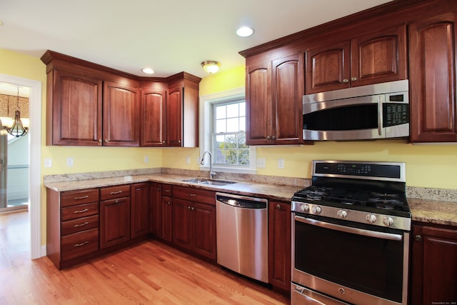 5 Marjories Way Unit 5, East Lyme, CT 06357 - kitchen featuring stainless steel appliances, a sink, light wood-style flooring, recessed lighting, and light stone countertops