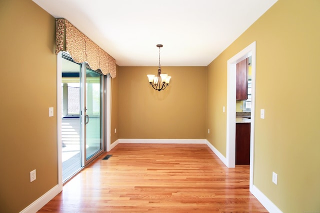 5 Marjories Way Unit 5, East Lyme, CT 06357 - unfurnished dining area featuring a chandelier, light wood-style floors, and baseboards