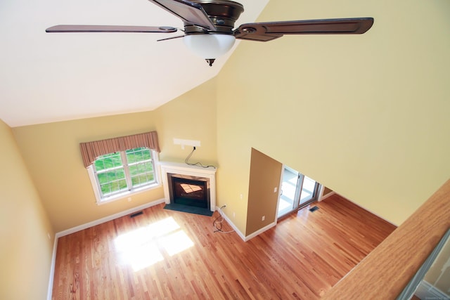 5 Marjories Way Unit 5, East Lyme, CT 06357 - unfurnished living room featuring wood finished floors, ceiling fan, a fireplace with flush hearth, baseboards, and high vaulted ceiling