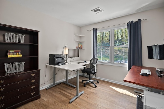 office area featuring baseboards, wood finished floors, and visible vents