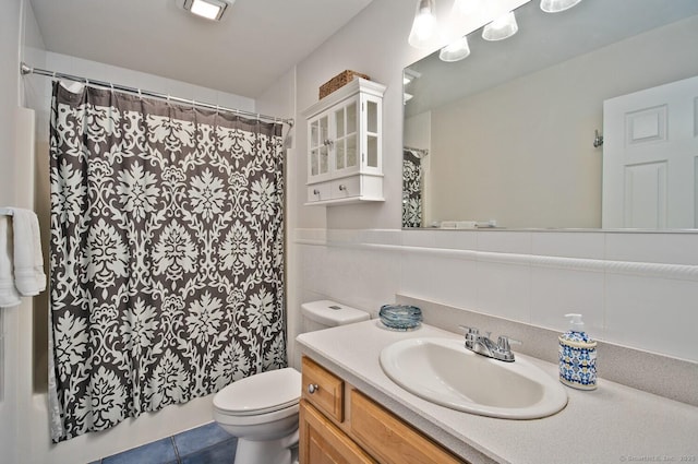 full bath with vanity, a shower with shower curtain, tile patterned flooring, and toilet