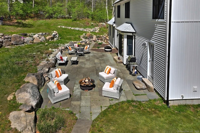 view of yard with an outdoor living space with a fire pit and a patio area
