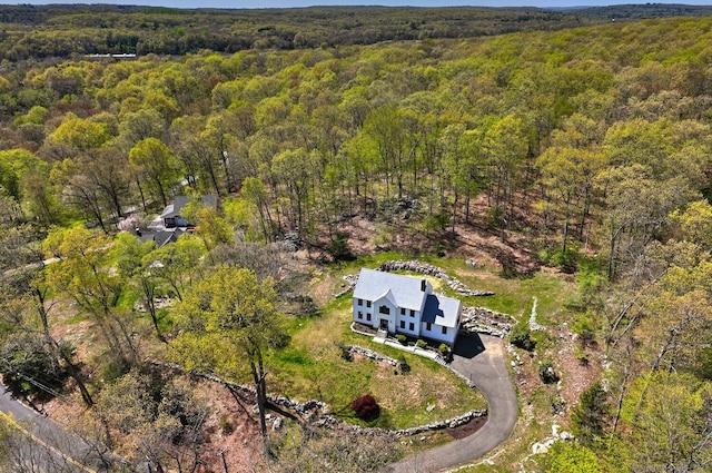 birds eye view of property with a wooded view