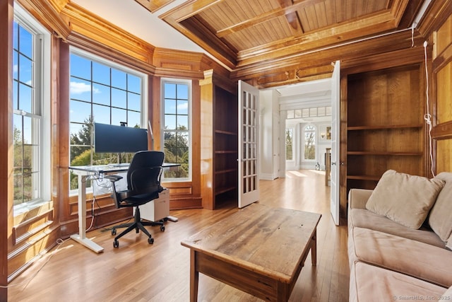 home office with light wood-type flooring, wooden ceiling, crown molding, wooden walls, and plenty of natural light