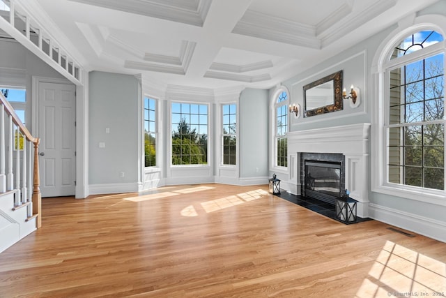 unfurnished living room with a fireplace, stairway, baseboards, visible vents, and light wood-style floors