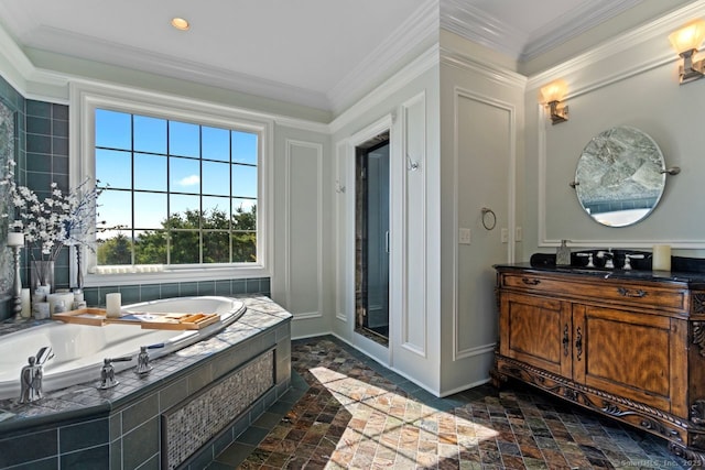 bathroom with vanity, stone tile floors, crown molding, baseboards, and a bath