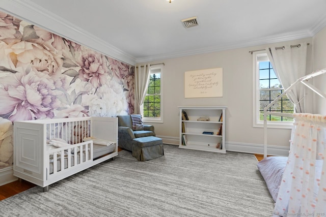 bedroom with crown molding, visible vents, and multiple windows