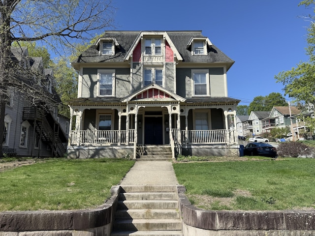 221 Broadway, Norwich, CT 06360 - view of front of house with roof with shingles, a porch, and a front lawn