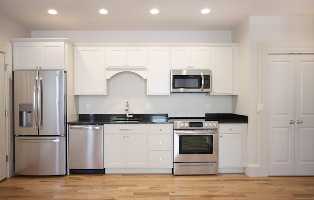 221 Broadway, Norwich, CT 06360 - kitchen with a sink, light wood-style flooring, stainless steel appliances, recessed lighting, and white cabinetry