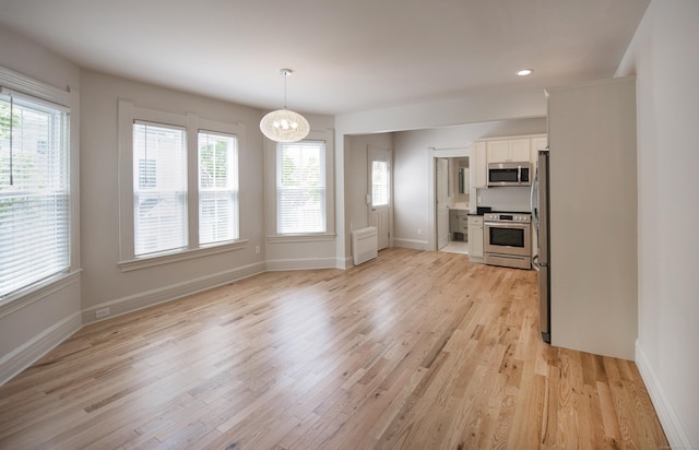 221 Broadway, Norwich, CT 06360 - unfurnished dining area featuring an inviting chandelier, baseboards, recessed lighting, and light wood finished floors