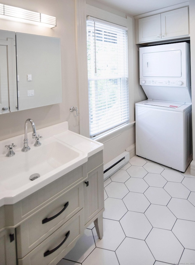 221 Broadway, Norwich, CT 06360 - bathroom featuring vanity, stacked washer and dryer, baseboard heating, and a wealth of natural light