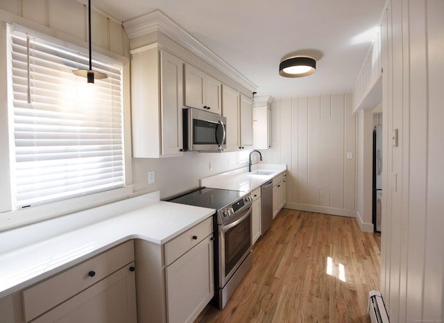 221 Broadway, Norwich, CT 06360 - kitchen featuring a sink, light wood-style flooring, appliances with stainless steel finishes, and light countertops