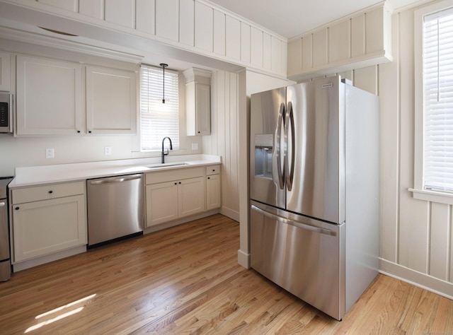 221 Broadway, Norwich, CT 06360 - kitchen featuring light wood-type flooring, a sink, appliances with stainless steel finishes, and light countertops