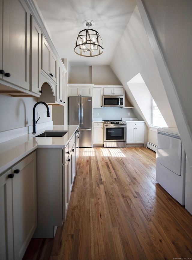 221 Broadway, Norwich, CT 06360 - kitchen featuring washer / clothes dryer, wood finished floors, a sink, light countertops, and stainless steel appliances