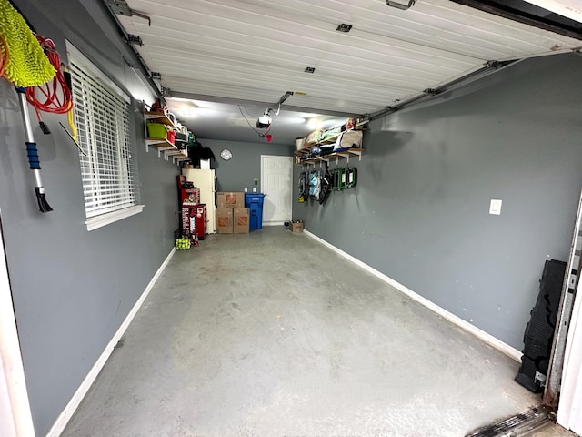 103D Wendover Dr Unit D, Monroe, CT 06468 - garage featuring a garage door opener and baseboards
