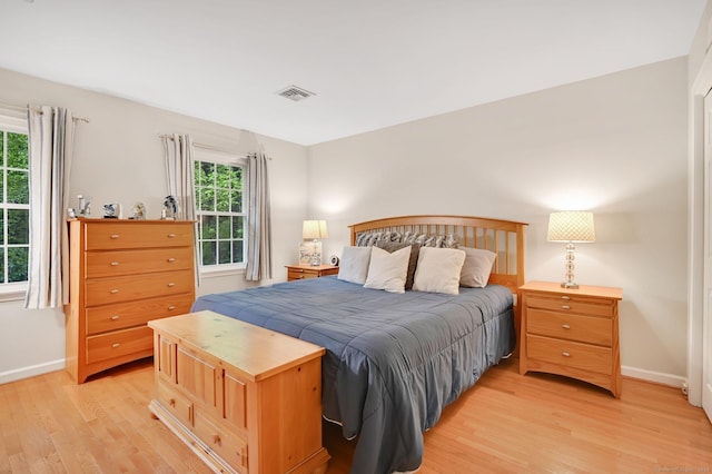 bedroom featuring light wood-style flooring and baseboards