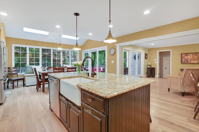 kitchen featuring a sink, dishwasher, light wood finished floors, dark brown cabinetry, and recessed lighting