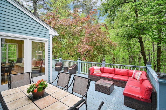 deck featuring outdoor lounge area and outdoor dining space