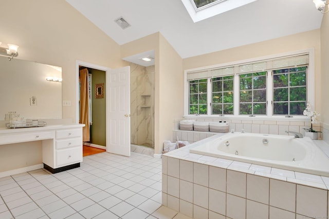 bathroom with vaulted ceiling, a whirlpool tub, a stall shower, tile patterned floors, and a skylight