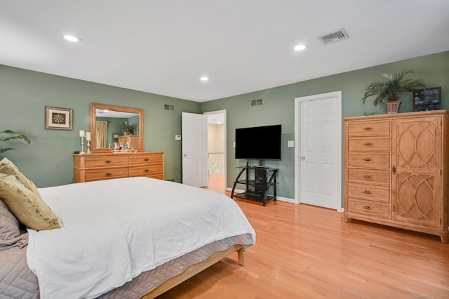 bedroom with light wood finished floors, baseboards, and recessed lighting