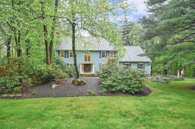 colonial home with a front lawn