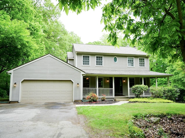 171 Charles Ln, Hebron, CT 06248 - view of front facade featuring asphalt driveway, covered porch, an attached garage, and a front lawn