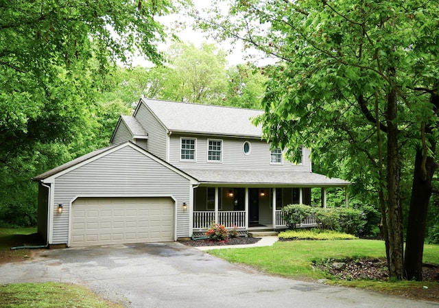 171 Charles Ln, Hebron, CT 06248 - view of front of house with a porch, driveway, an attached garage, and a front yard