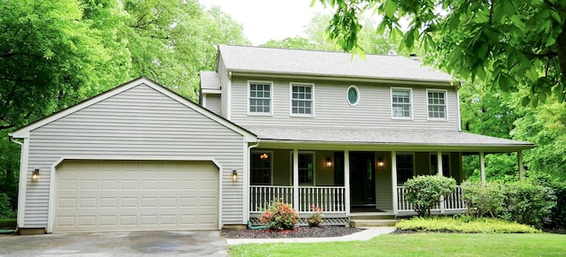 171 Charles Ln, Hebron, CT 06248 - view of front facade featuring covered porch, concrete driveway, and a garage