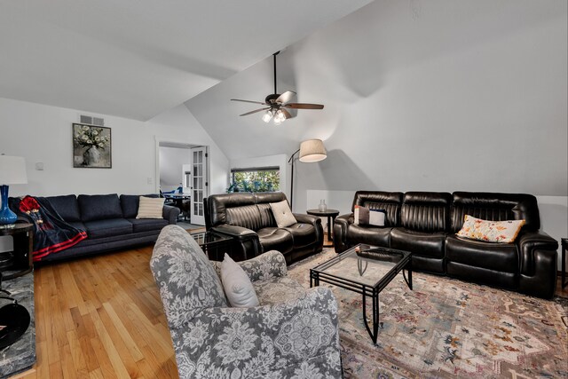 living room with visible vents, a ceiling fan, wood finished floors, and lofted ceiling