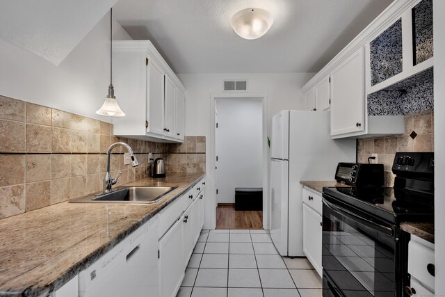 kitchen featuring visible vents, electric range, white dishwasher, white cabinetry, and a sink