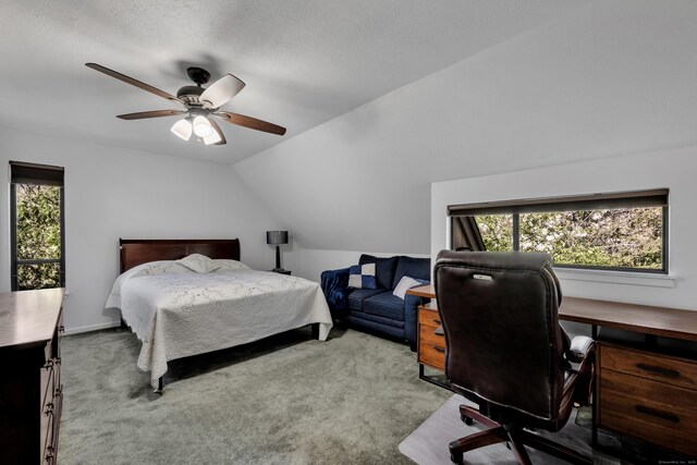 carpeted bedroom featuring a ceiling fan and vaulted ceiling