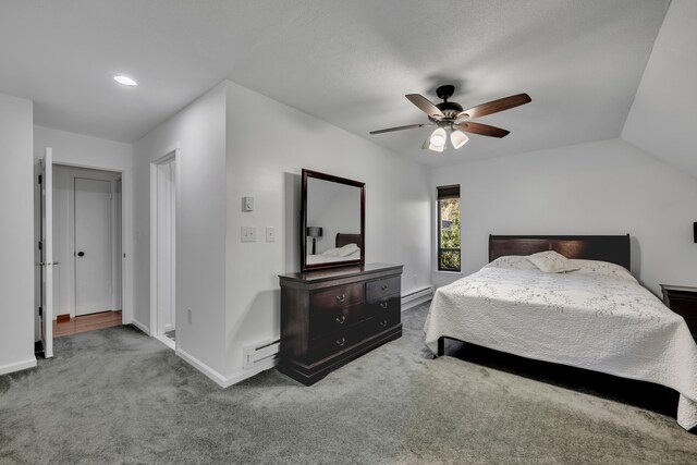 bedroom featuring a ceiling fan, baseboards, carpet, and a baseboard heating unit